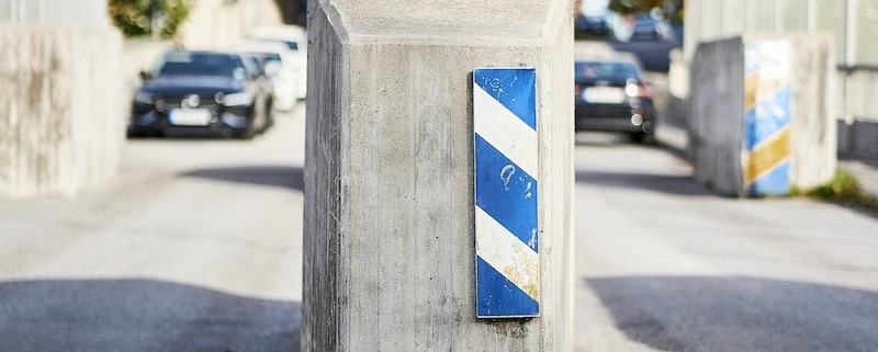 a blue and white box sitting on the side of a road
