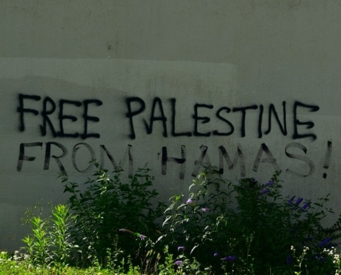A sign that says free palestine written on the side of a building
