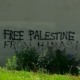 A sign that says free palestine written on the side of a building